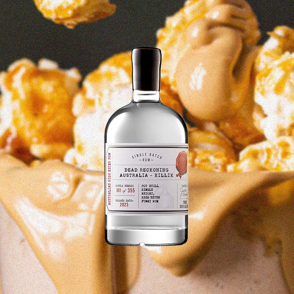 Bottle of Dead Reckoning Killik Australian White Rum over back drop image of popcorn.