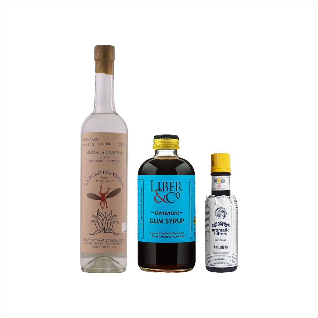 Bottles of La Puritita Verda Mezcal, Liber & Co Demerara Gum Syrup, and Angostura Aromatic Bitters.