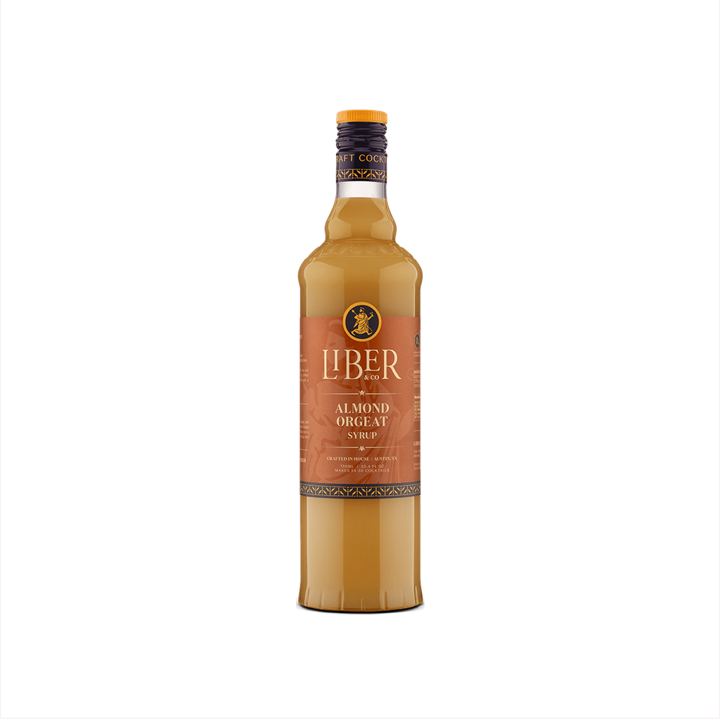 A bottle of Liber & Co. Almond Orgeat Syrup with a label showcasing the brand and product name, set against a plain background.