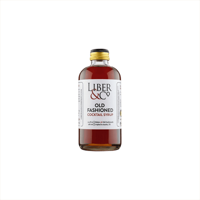 A small premium bottle of warm red liquid, the label reads: Liber & Co Old Fashioned Cocktail Syrup product image
