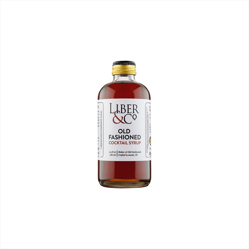 A small premium bottle of warm red liquid, the label reads: Liber & Co Old Fashioned Cocktail Syrup