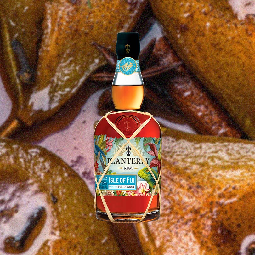 Bottle of Planteray Isle of Fiji Rum over backdrop image of plantains.