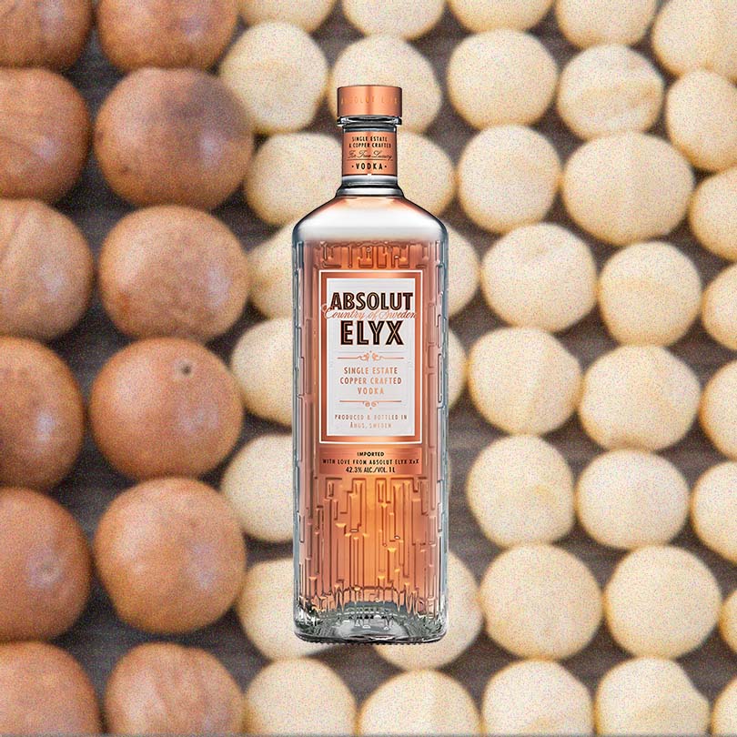 Bottle of Absolut Elyx Vodka over backdrop of baked goods.