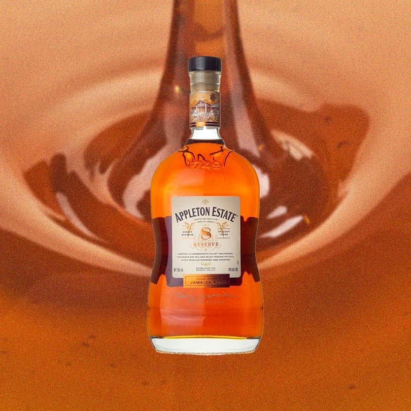 Bottle of Appleton Estate 8 Year Reserve over backdrop of syrup.