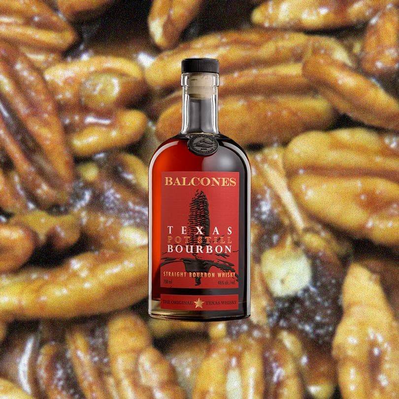 Bottle of Balcones Texas Pot Still Bourbon. Backdrop of Pecans.
