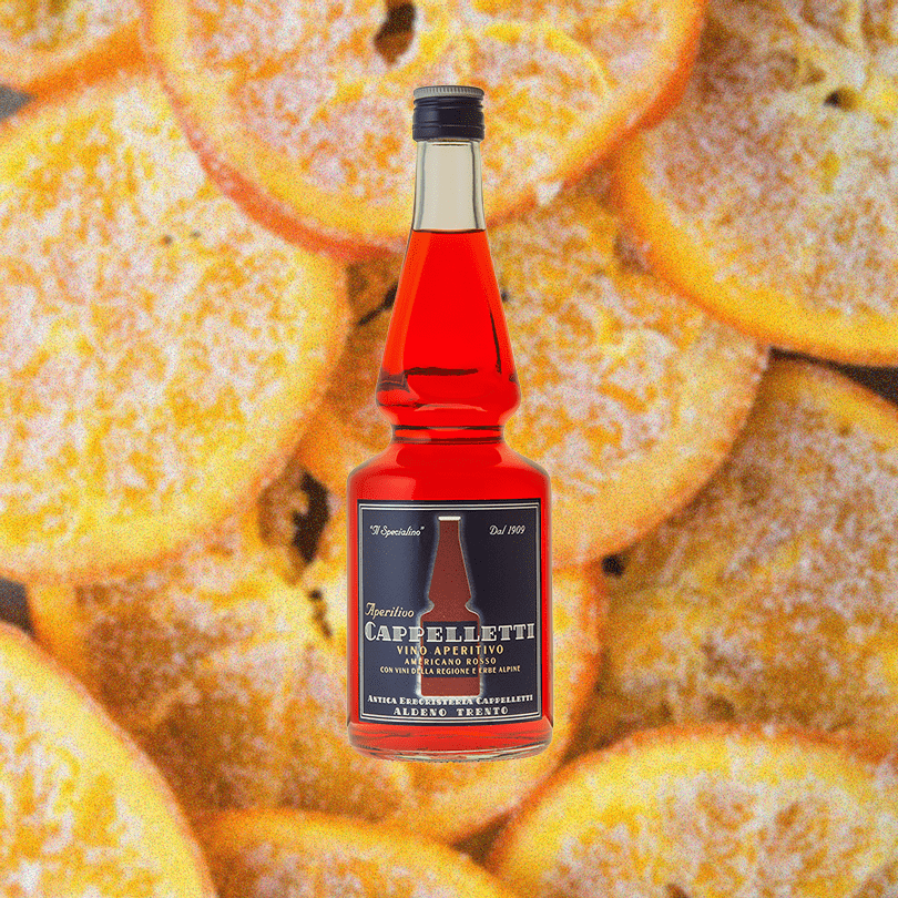 Bottle of Cappelletti and faded backdrop of dried sugared orange slices.