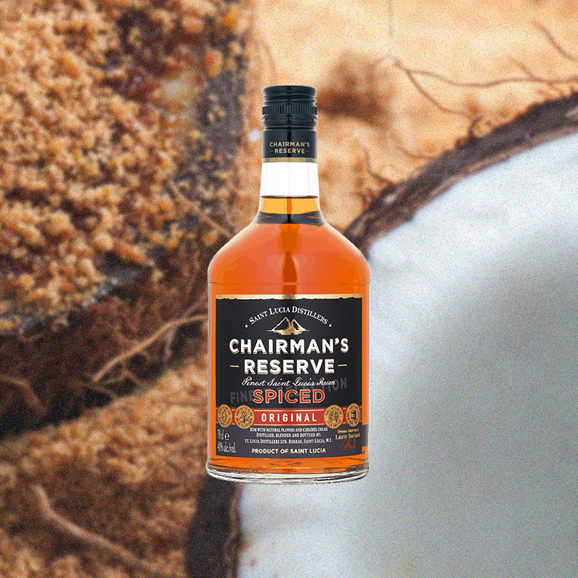 Bottle of Chairman's Reserve Spiced Rum over backdrop of chocolate baked goods.