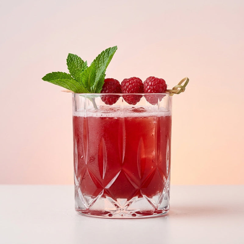A photo of the Bramble Bourbon Smash cocktail containing Raspberries, Savage & Cooke Cask Finished Bourbon, Combier Crème de Mûre Blackberry Liqueur, Freshly squeezed lemon juice, Giffard Sugar Cane Syrup (Sirop Sucre de Canne) in a Old-Fashioned.