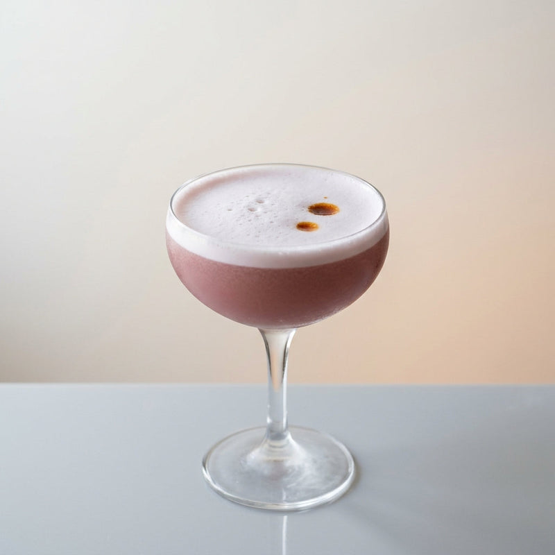 A photo of the Cognac Velvet Sour cocktail containing Hennessy V.S. Cognac, Chambord Liqueur, Freshly squeezed lemon juice, Giffard Sugar Cane Syrup (Sirop Sucre de Canne), Fee Brothers Fee Foam Egg White Alternative in a Coupe.