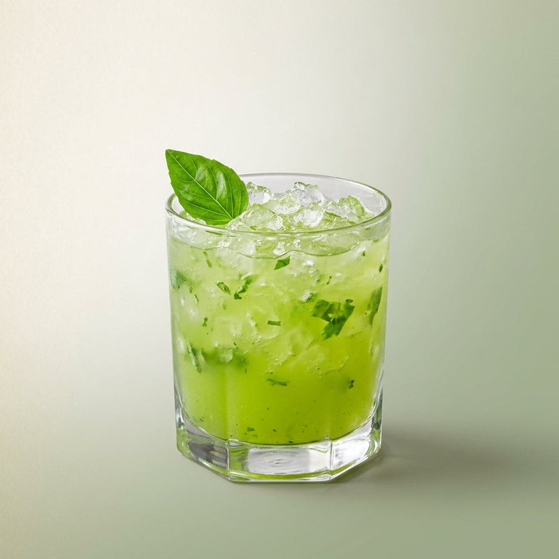 A photo of the Basil Lemon Drop on the Rocks cocktail containing Basil leaves, Ketel One Vodka, Pallini Limoncello, Freshly squeezed lemon juice, Giffard Sugar Cane Syrup (Sirop Sucre de Canne) in a Old-Fashioned.