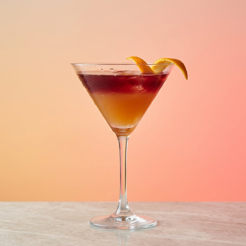 A photo of the The Bourbon Martini cocktail containing Savage & Cooke Cask Finished Bourbon, Claret red wine, Freshly squeezed lemon juice, Giffard Sugar Cane Syrup (Sirop Sucre de Canne) in a Martini.
