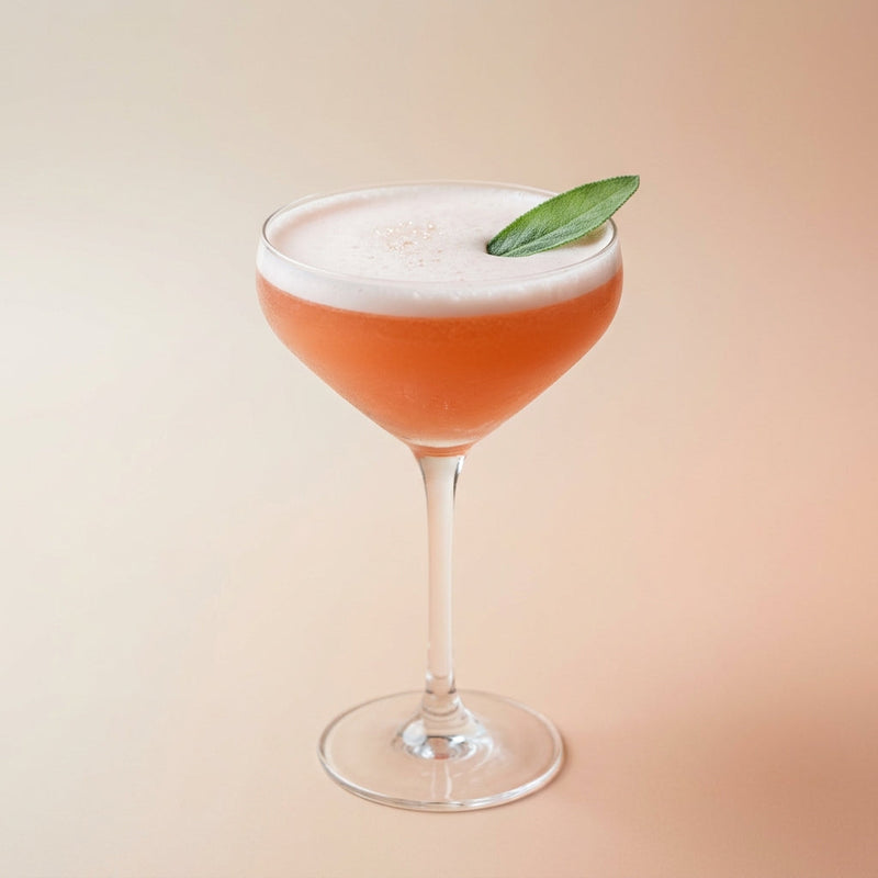 A photo of the The Sage & Citrus Silk cocktail containing Blood orange juice, Sage leaves, Beefeater London Dry Gin, Freshly squeezed lime juice, Giffard Sugar Cane Syrup (Sirop Sucre de Canne), Fee Brothers Fee Foam Egg White Alternative in a Martini.