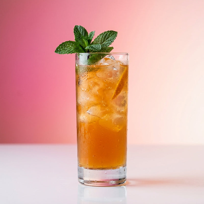 A photo of the Parisian Mint Collins cocktail containing Hennessy V.S. Cognac, Bénédictine D.O.M. Liqueur, Giffard Sugar Cane Syrup (Sirop Sucre de Canne), Freshly squeezed orange juice in a Collins.