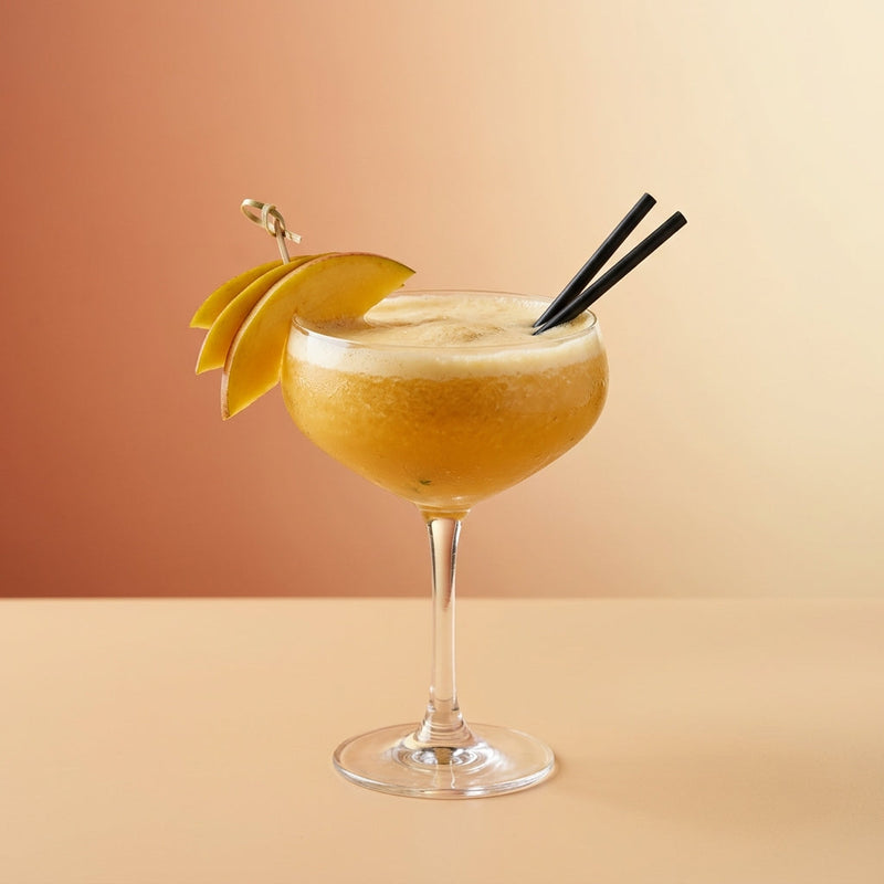 A photo of the Frozen Mango Margarita cocktail containing Milagro Reposado Tequila, Mango purée, Giffard Triple Sec, Freshly squeezed lime juice, Giffard Sugar Cane Syrup (Sirop Sucre de Canne) in a Coupe.