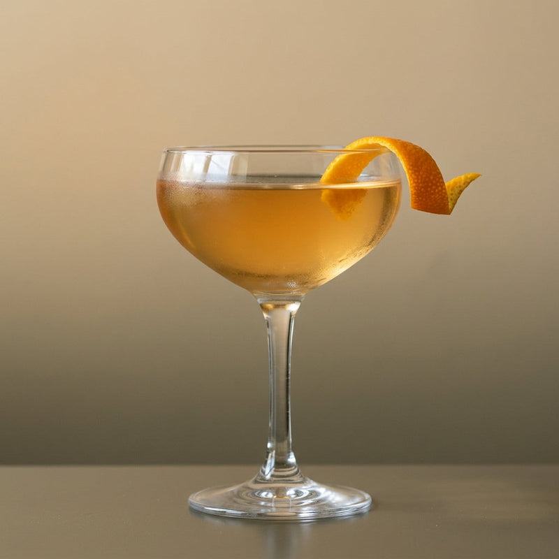 A photo of the The Verdant Martini cocktail containing Beefeater London Dry Gin, Baldoria Verdant Vermouth, Suze Aperitif, Pernod Absinthe in a Coupe.