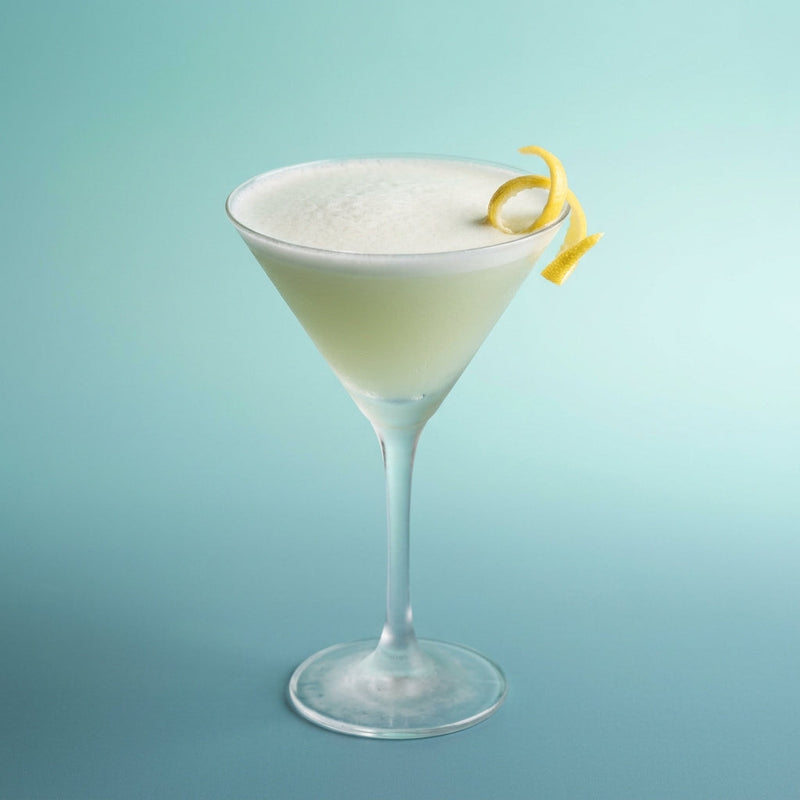 A photo of the The Green Fairy Fizz cocktail containing Pernod Absinthe, Freshly squeezed lemon juice, Chilled water, Giffard Sugar Cane Syrup (Sirop Sucre de Canne), Angostura Aromatic Bitters, Fee Brothers Fee Foam Egg White Alternative in a Martini.