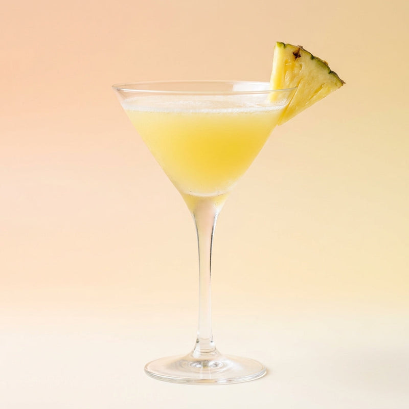 A photo of the Pineapple Drop Martini cocktail containing Ketel One Vodka, Fresh pressed pineapple juice, Freshly squeezed lime juice, Giffard Sugar Cane Syrup (Sirop Sucre de Canne) in a Martini.