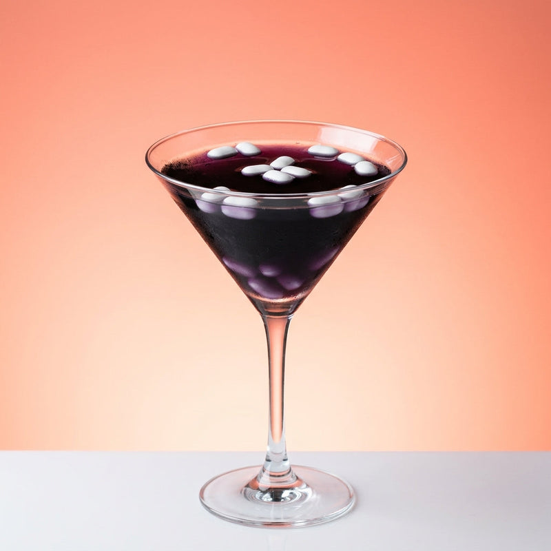 A photo of the Midnight Mint Martini cocktail containing Ketel One Vodka, Romana Black Sambuca Liqueur, Tempus Fugit Crème De Menthe in a Martini.