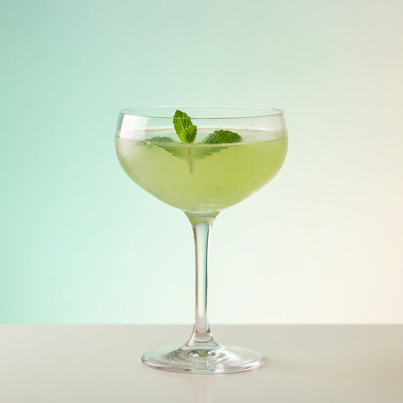 A photo of the Hi Ladies! cocktail containing Ketel One Vodka, Mint leaves, Freshly squeezed lime juice, Giffard Sugar Cane Syrup (Sirop Sucre de Canne) in a Coupe.