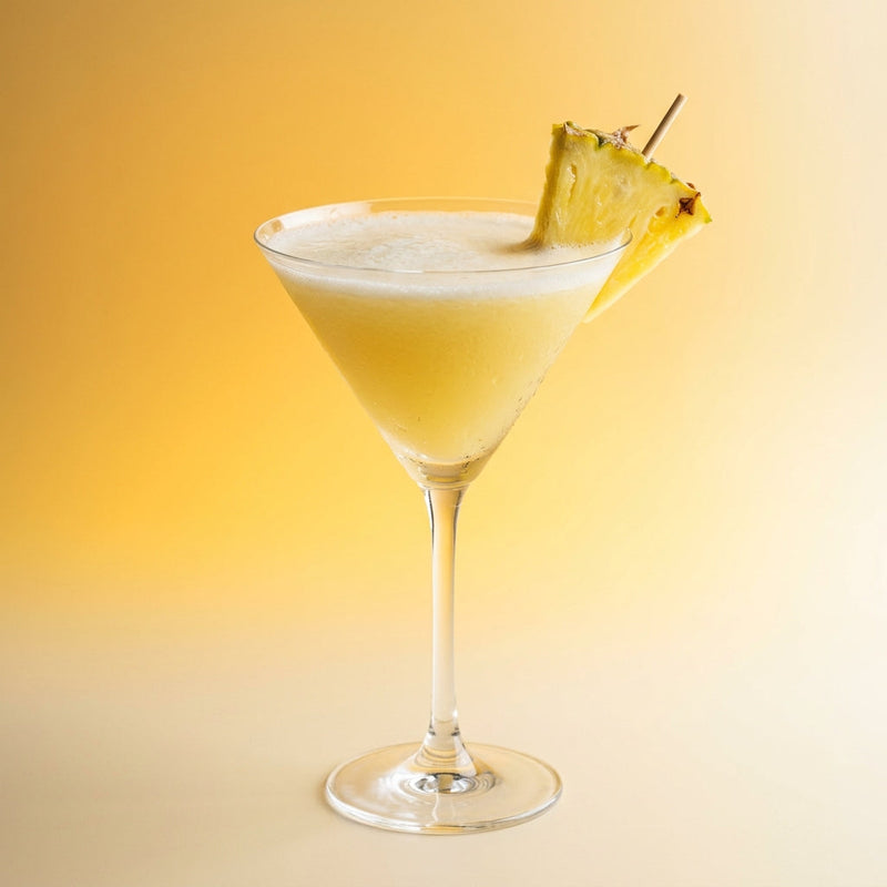A photo of the Pineapple Harvest Martini cocktail containing Ketel One Vodka, Fresh pressed pineapple juice, Galliano Autentico Liqueur, Freshly squeezed lime juice, Giffard Sugar Cane Syrup (Sirop Sucre de Canne) in a Martini.