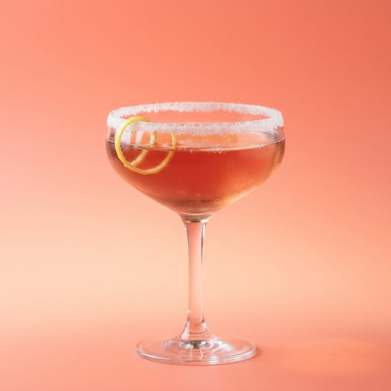 A photo of the French Kiss Royale cocktail containing Hennessy V.S. Cognac, Freshly squeezed lemon juice, Giffard Sugar Cane Syrup (Sirop Sucre de Canne), Chambord Liqueur, Saline solution 10:1 (5g sea salt to 50ml water) in a Coupe.