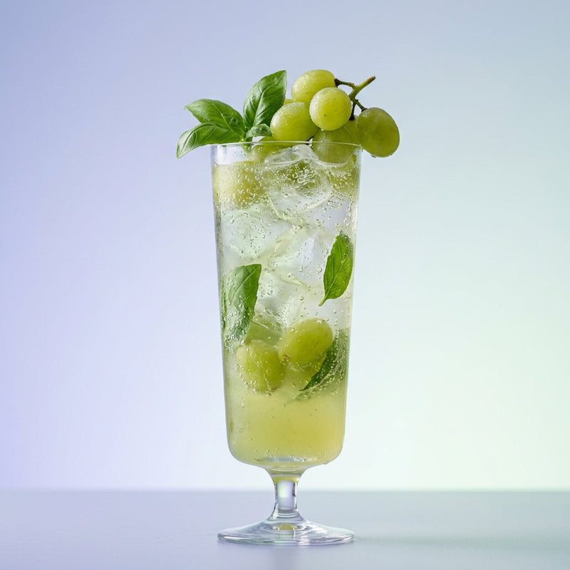 A photo of the Fleur Verte Fizz cocktail containing Basil leaves, Pernod Absinthe, St-Germain Elderflower Liqueur, Freshly squeezed lime juice, Giffard Sugar Cane Syrup (Sirop Sucre de Canne), Ginger ale in a Collins.