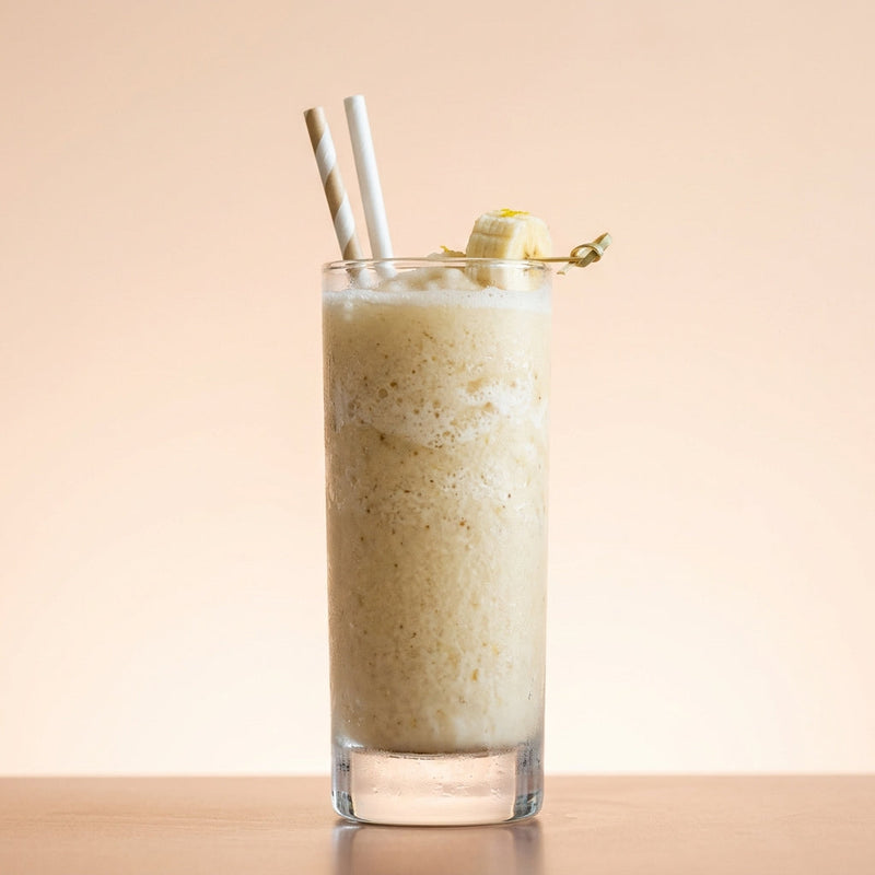 A photo of the Banana Cow cocktail containing Planteray 3 Stars White Rum, Milk, Giffard Sugar Cane Syrup (Sirop Sucre de Canne), Angostura Aromatic Bitters, Vanilla extract, Banana (peeled) in a Collins.