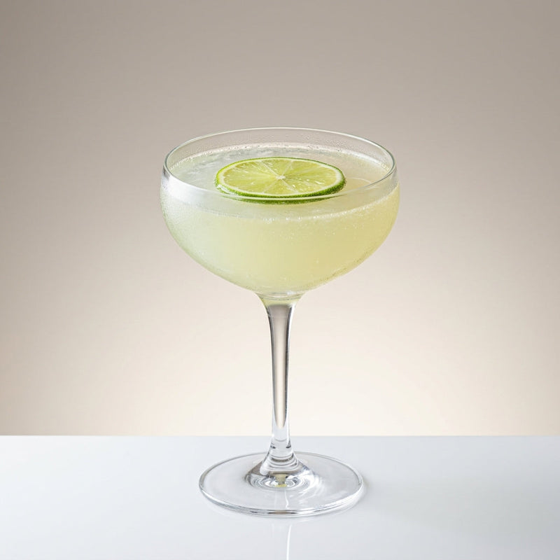 A photo of the Blanche Mystique cocktail containing Planteray 3 Stars White Rum, Bénédictine D.O.M. Liqueur, Pernod Absinthe, Freshly squeezed lime juice, Giffard Sugar Cane Syrup (Sirop Sucre de Canne), Chilled water (reduce if wet ice) in a Coupe.