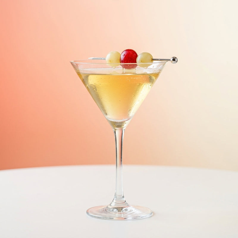A photo of the Grape Blanc cocktail containing Seedless white grapes, Planteray 3 Stars White Rum, St-Germain Elderflower Liqueur in a Martini.