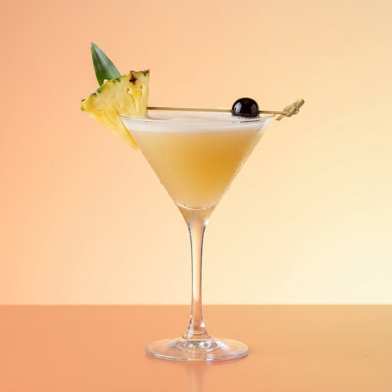 A photo of the Tropical Gin Martini cocktail containing Beefeater London Dry Gin, Fresh pressed pineapple juice, Giffard Sugar Cane Syrup (Sirop Sucre de Canne) in a Martini.