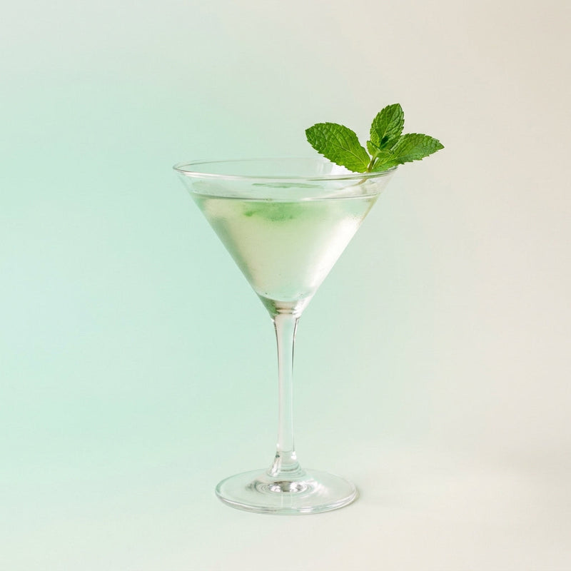 A photo of the Frosty Mint Martini cocktail containing Mint leaves, Ketel One Vodka, Giffard Sugar Cane Syrup (Sirop Sucre de Canne), Freshly squeezed lime juice in a Martini.