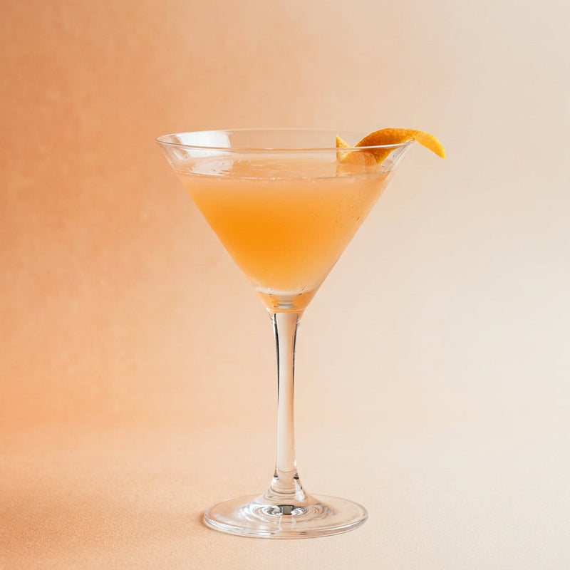A photo of the Apricot Cosmo cocktail containing Ketel One Vodka, Giffard Triple Sec, Giffard Abricot Du Roussillon, Freshly squeezed lime juice, Giffard Sugar Cane Syrup (Sirop Sucre de Canne) in a Martini.