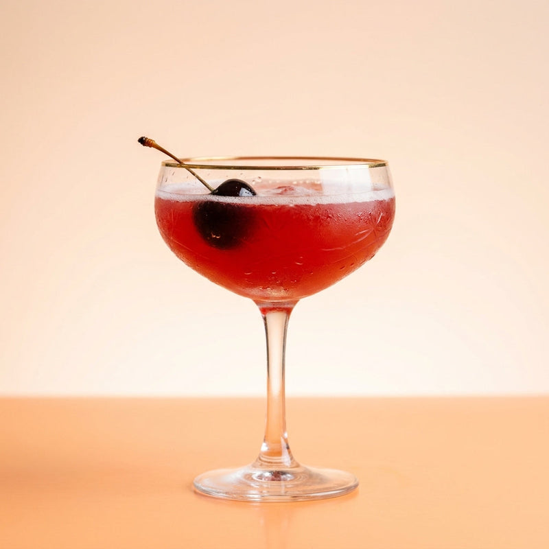 A photo of the Cherry Metropole cocktail containing Hennessy V.S. Cognac, Dubonnet Rouge, Heering Cherry Liqueur, Blood orange juice, Freshly squeezed lemon juice, Chilled water (reduce if wet ice) in a Coupe.