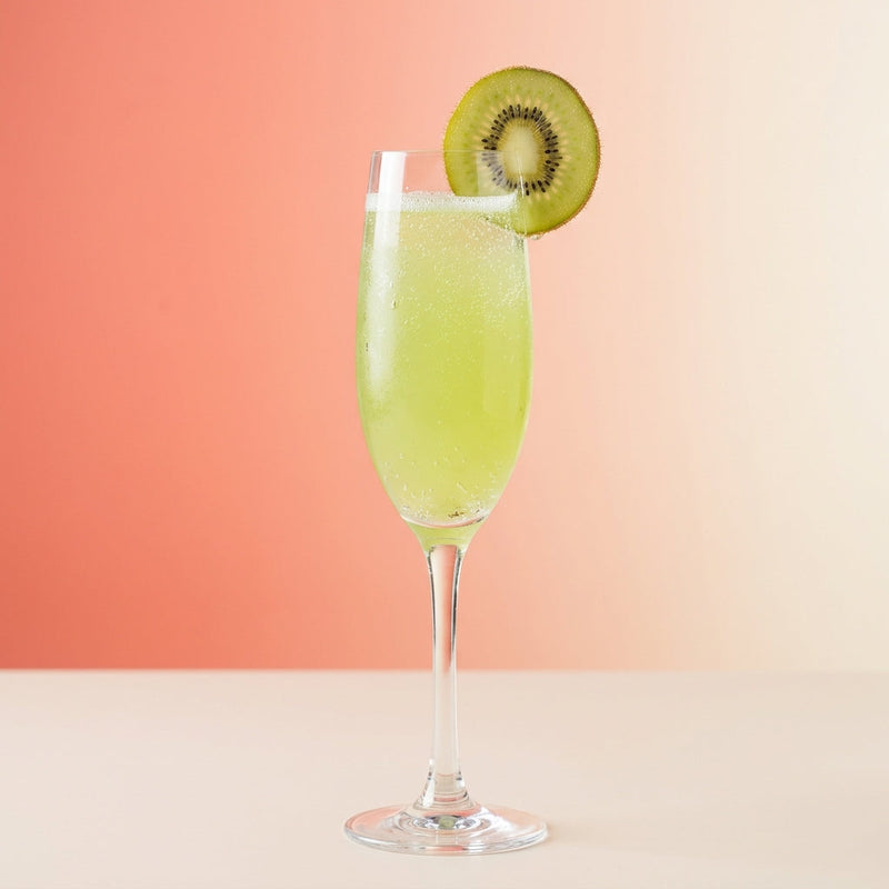A photo of the Kiwi Fizz Royale cocktail containing Kiwi fruit, Ketel One Vodka, Freshly squeezed lemon juice, Giffard Sugar Cane Syrup (Sirop Sucre de Canne), La Marca Prosecco in a Flute.