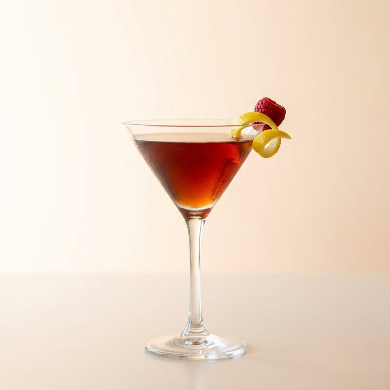 A photo of the Crimson Cognac Martini cocktail containing Hennessy V.S. Cognac, Giffard Triple Sec, Chambord Liqueur, Martini & Rossi Rosso Sweet Vermouth in a Martini.