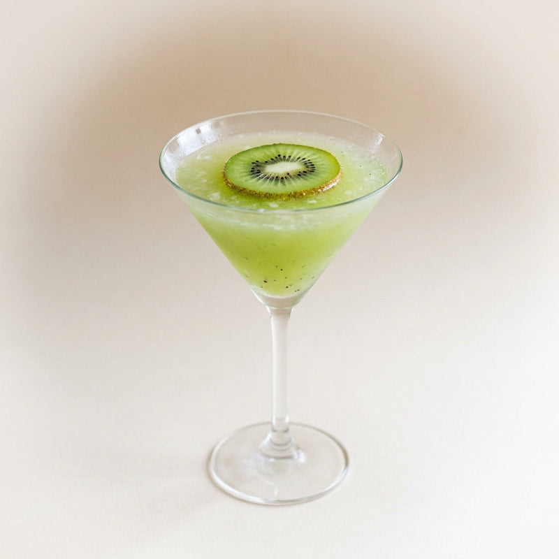 A photo of the Kiwi Martini cocktail containing Kiwi fruit, Ketel One Vodka, Giffard Sugar Cane Syrup (Sirop Sucre de Canne) in a Martini.