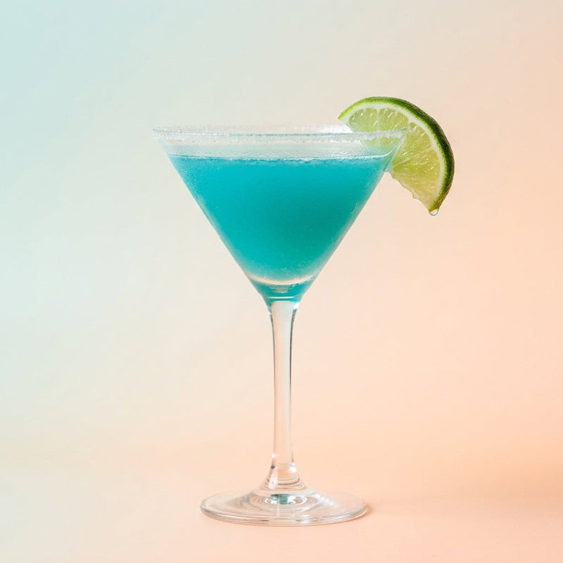 A photo of the Blue Caribbean Sidecar cocktail containing Planteray 3 Stars White Rum, Giffard Triple Sec, Giffard Blue Curaçao, Freshly squeezed lime juice, Fresh pressed pineapple juice in a Martini.