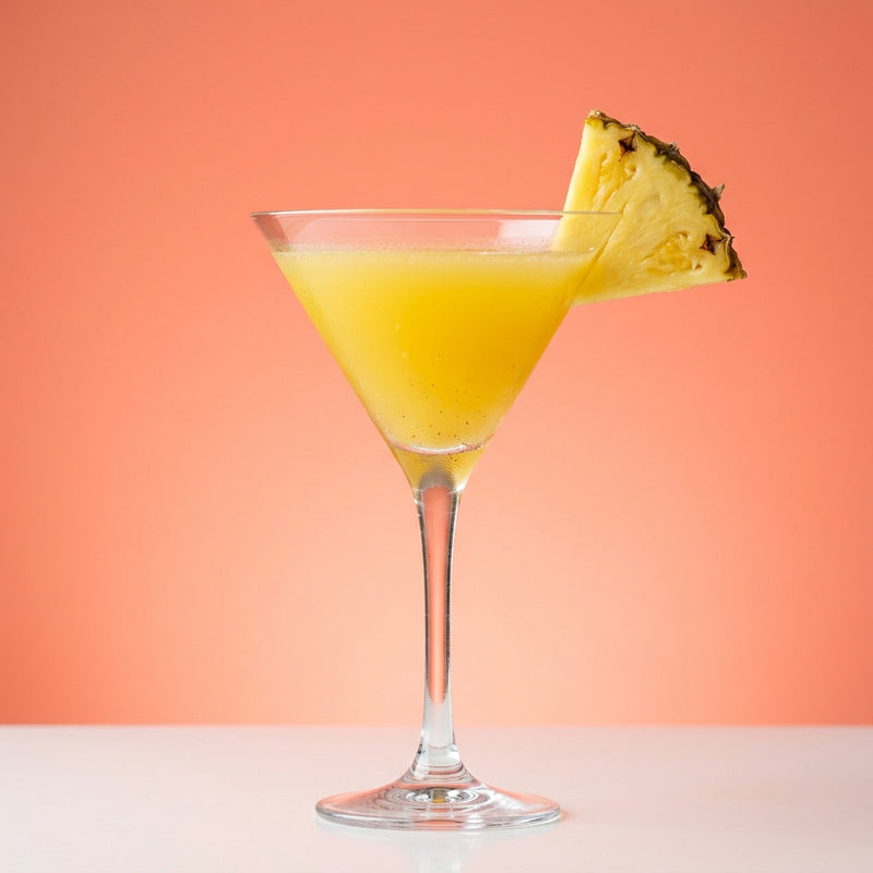 A photo of the Cardamom Pineapple Martini cocktail containing Cardamom pod, Ketel One Vodka, Fresh pressed pineapple juice, Giffard Sugar Cane Syrup (Sirop Sucre de Canne) in a Martini.