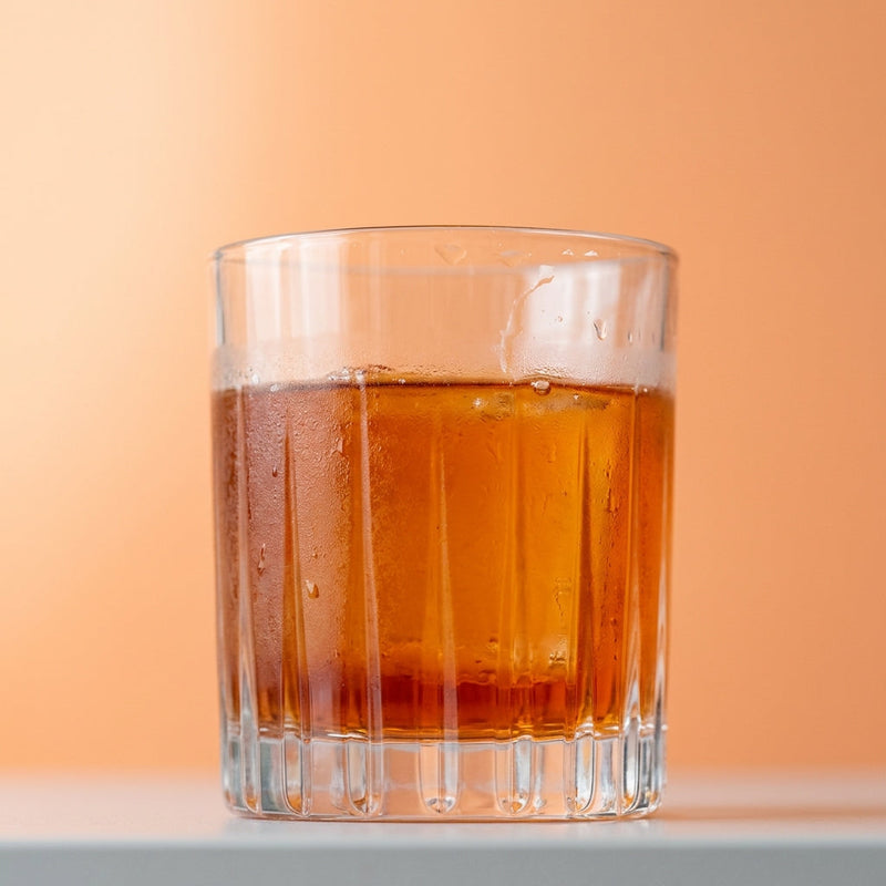 A photo of the Emerald Sazerac cocktail containing Pernod Absinthe, Beefeater London Dry Gin, Giffard Triple Sec, Giffard Sugar Cane Syrup (Sirop Sucre de Canne), Peychaud's Bitters in a Old-Fashioned.