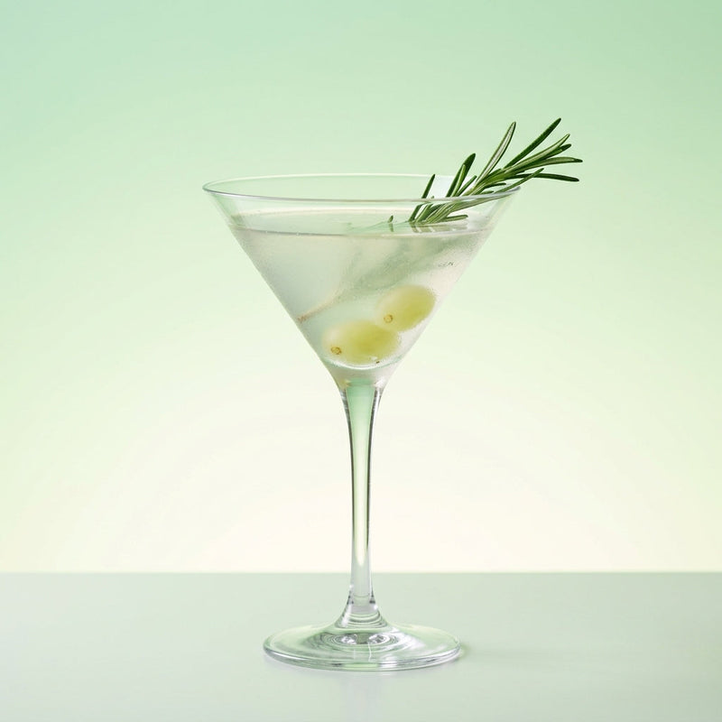 A photo of the Rosemary Grape Gin Martini cocktail containing Rosemary sprig, Seedless white grapes, Beefeater London Dry Gin, St-Germain Elderflower Liqueur, Freshly squeezed lime juice in a Martini.