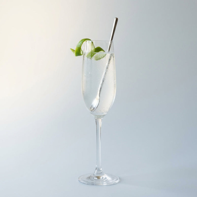 A photo of the Fleur Fizz cocktail containing Ketel One Vodka, St-Germain Elderflower Liqueur, Freshly squeezed lime juice, Club soda in a Flute.