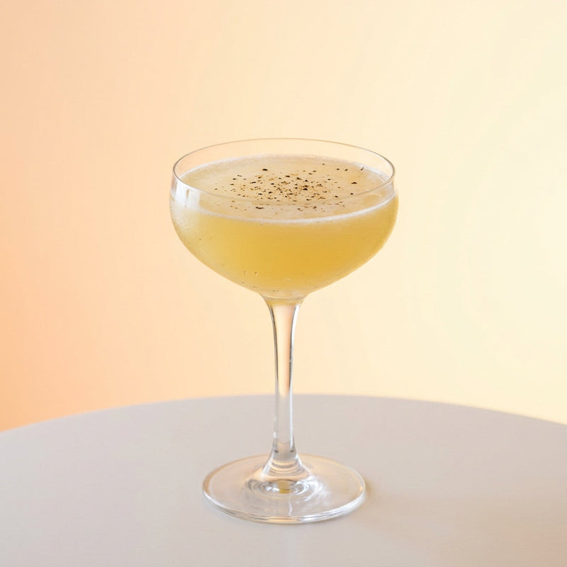 A photo of the Peachy Keen Gimlet cocktail containing Beefeater London Dry Gin, Rothman & Winter Orchard Peach Liqueur, Freshly squeezed lemon juice, Fresh pressed pineapple juice in a Coupe.