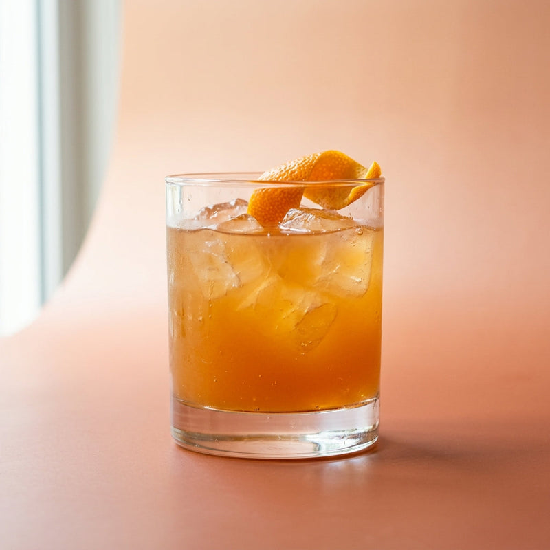 A photo of the Bourbon Grapefruit Smash cocktail containing Maple syrup, Savage & Cooke Cask Finished Bourbon, Freshly squeezed pink grapefruit juice in a Old-Fashioned.