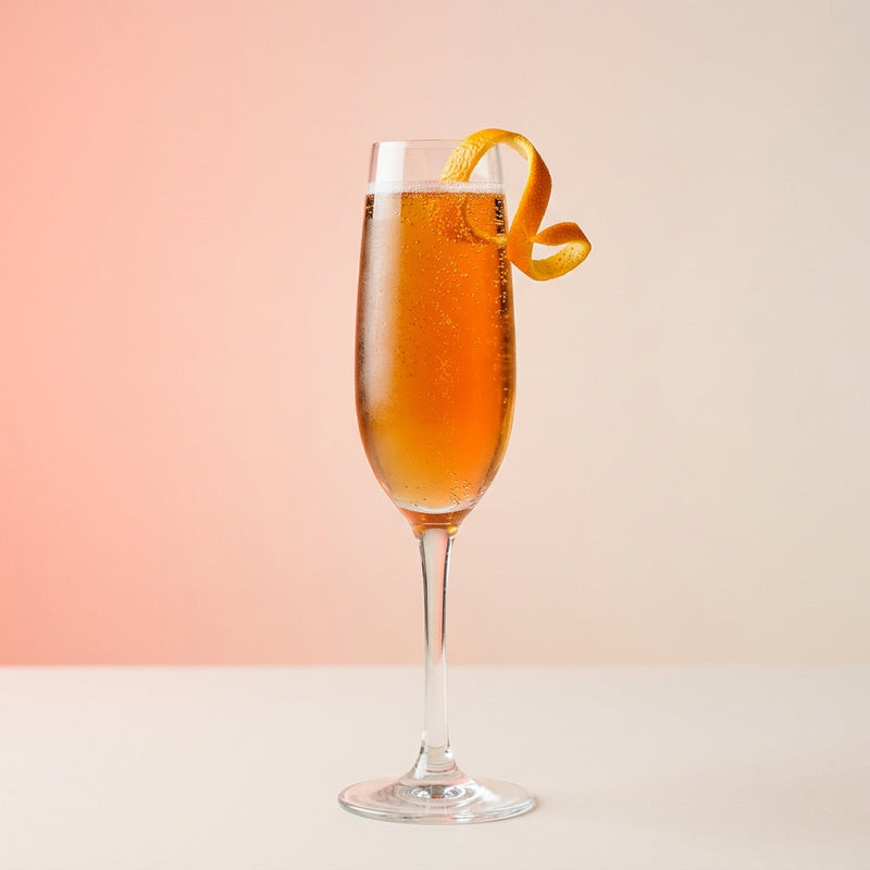 A photo of the Bourbon Blush Royale cocktail containing Savage & Cooke Cask Finished Bourbon, Giffard Triple Sec, Peychaud's Bitters, Angostura Aromatic Bitters, Perrier Jouet Grand Brut Champagne in a Flute.