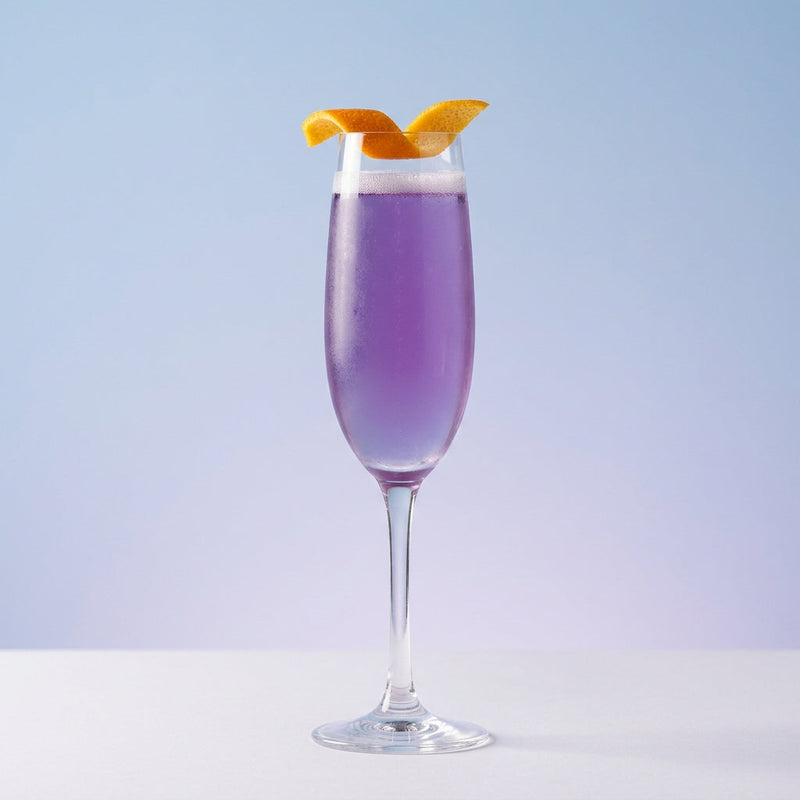 A photo of the Violet Aviation Fizz cocktail containing Beefeater London Dry Gin, Giffard Triple Sec, Giffard Crème de Violette Liqueur, Freshly squeezed lime juice, Freshly squeezed lemon juice in a Flute.