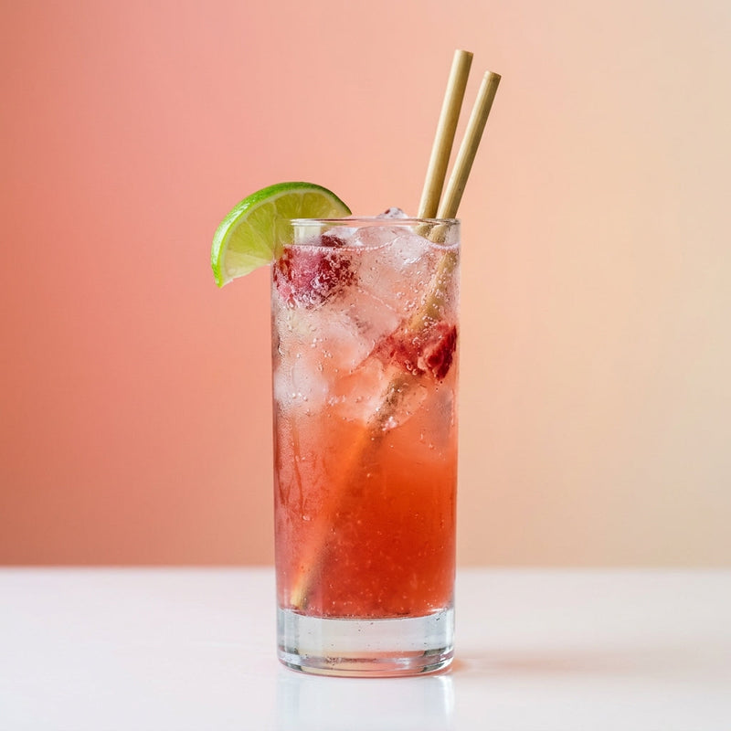 A photo of the Raspberry Moscow Mule cocktail containing Raspberries, Ketel One Vodka, Freshly squeezed lime juice, Giffard Sugar Cane Syrup (Sirop Sucre de Canne), Three Cents Ginger Beer in a Collins.