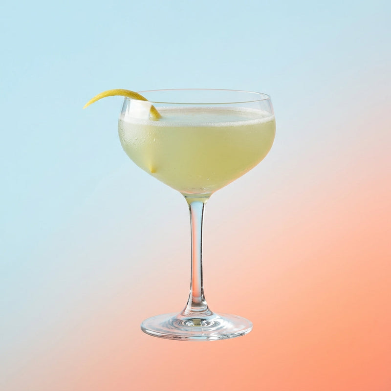 A photo of the Anise Dream cocktail containing Pernod Absinthe, Chilled water, Pressed apple juice, Giffard Orgeat Syrup, Freshly squeezed lime juice in a Coupe.