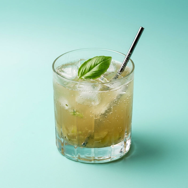 A photo of the Grape & Ginger Smash cocktail containing Seedless white grapes, Ketel One Vodka, Freshly squeezed lime juice, Barrow's Intense Ginger Liqueur, Giffard Sugar Cane Syrup (Sirop Sucre de Canne), Basil leaves in a Old-Fashioned.