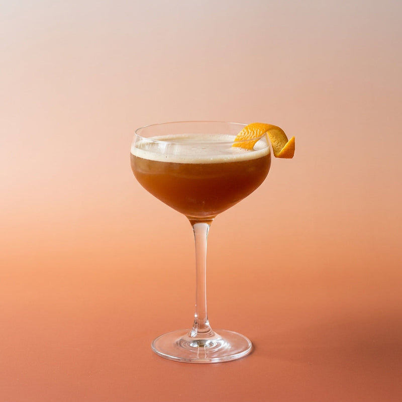 A photo of the Nutty Manhattan cocktail containing Savage & Cooke Cask Finished Bourbon, Martini & Rossi Rosso Sweet Vermouth, Trader Vic's Macadamia Nut Liqueur, Angostura Aromatic Bitters in a Coupe.