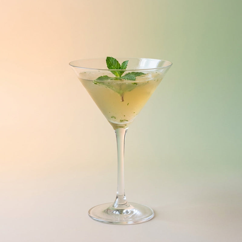 A photo of the Jamaican Gold Rush cocktail containing Mint leaves, Appleton Estate 8 Year Old Reserve Rum, Drambuie Liqueur, Freshly squeezed lime juice, Giffard Sugar Cane Syrup (Sirop Sucre de Canne) in a Martini.